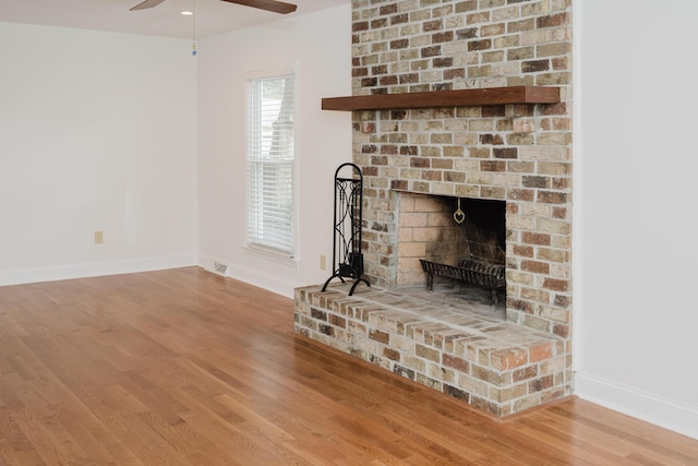 unfurnished living room featuring a fireplace and wood-type flooring