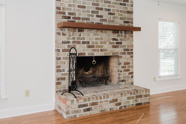 interior details with hardwood / wood-style flooring and a fireplace