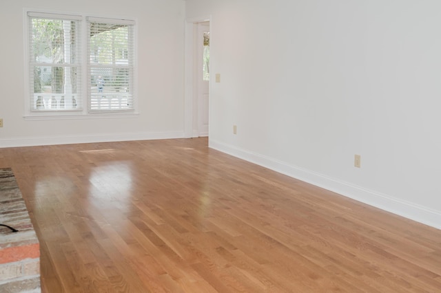 unfurnished room with light hardwood / wood-style floors and a wealth of natural light