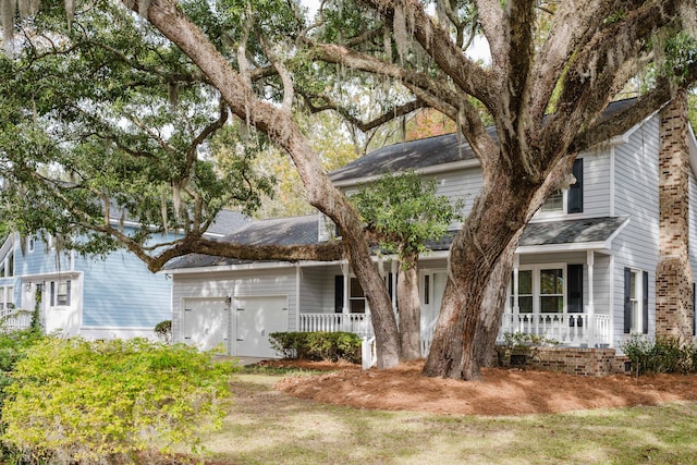 view of front of house featuring covered porch and a garage