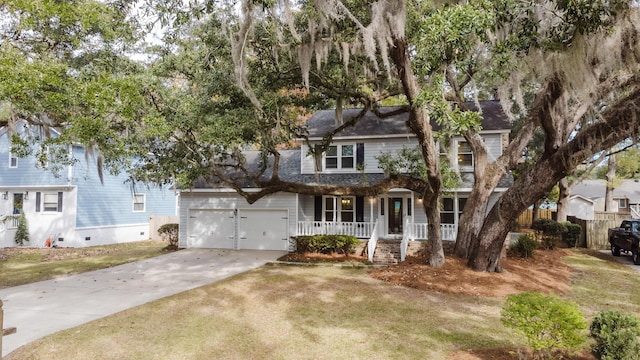 view of front of house with a porch, a garage, and a front lawn