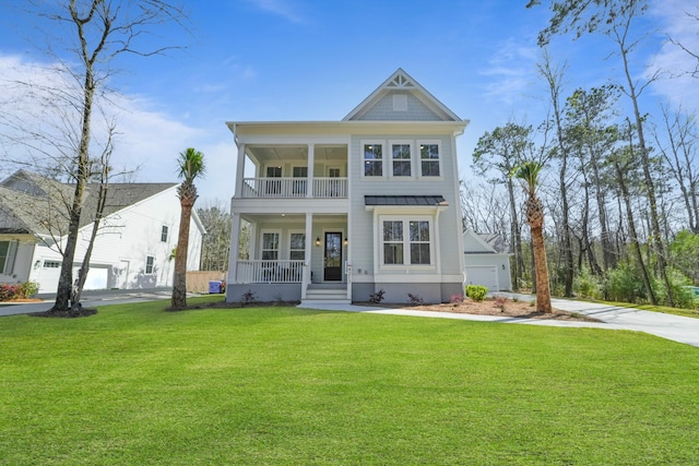 view of front of house featuring a balcony, a standing seam roof, covered porch, a front lawn, and a garage