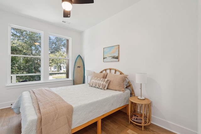 bedroom with ceiling fan and wood-type flooring