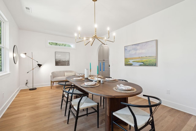 dining area with a chandelier and light hardwood / wood-style floors