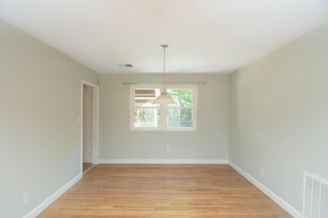 unfurnished dining area with light wood-type flooring