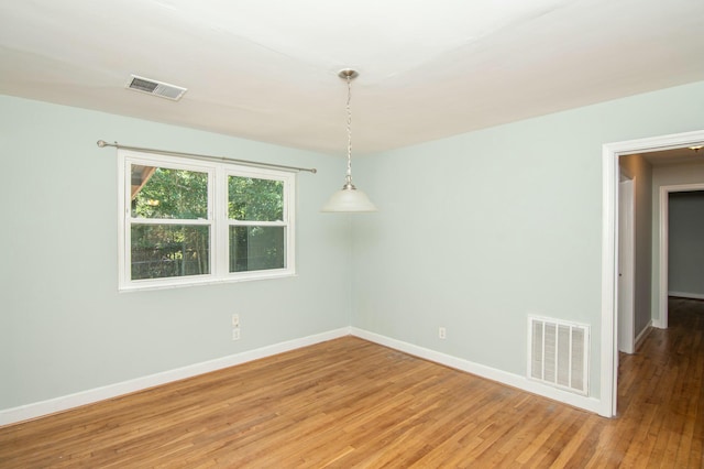 unfurnished room with hardwood / wood-style floors