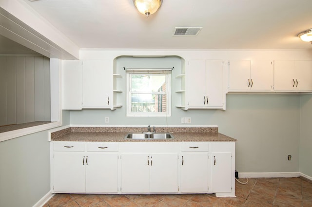 kitchen featuring white cabinets and sink