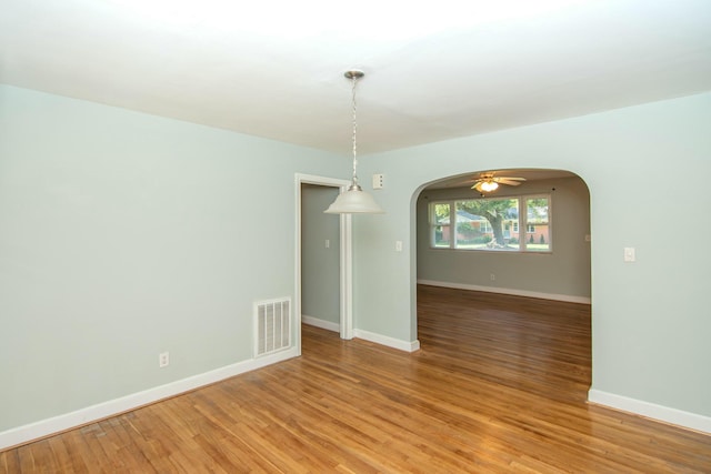 unfurnished dining area featuring ceiling fan and light hardwood / wood-style floors