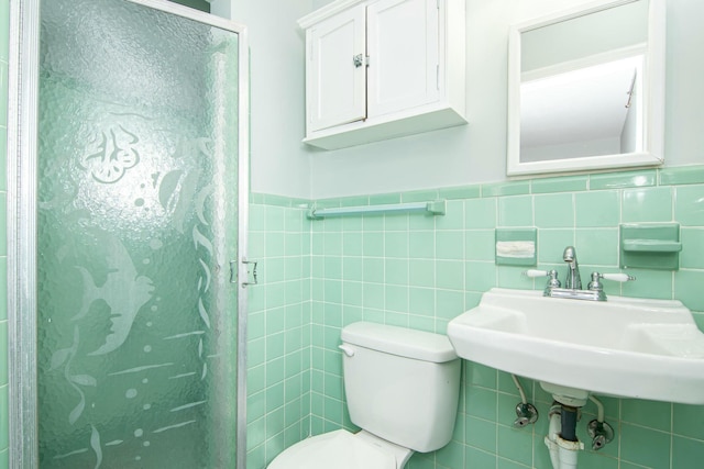 bathroom featuring sink, toilet, tile walls, and walk in shower