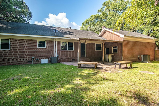 back of property featuring a patio, central AC unit, and a lawn