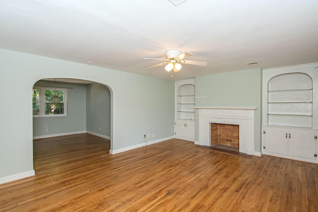 unfurnished living room with ceiling fan and hardwood / wood-style flooring