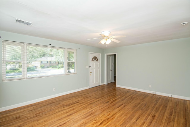 empty room with ceiling fan and wood-type flooring