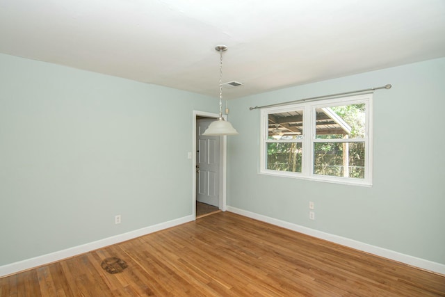 spare room with hardwood / wood-style floors