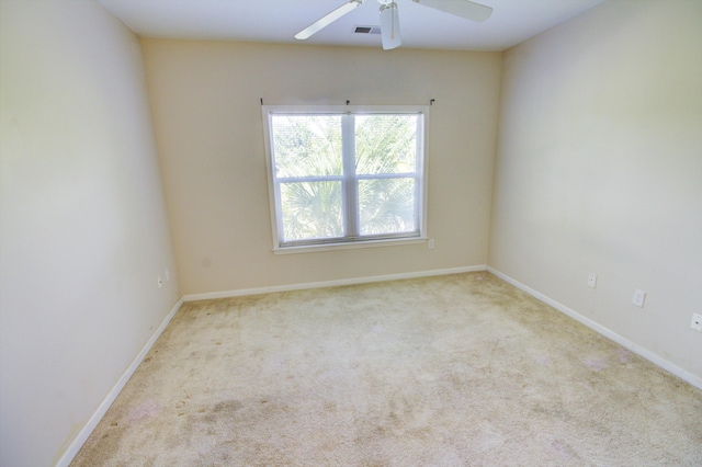 carpeted spare room with ceiling fan