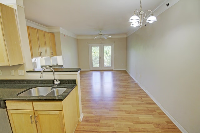 kitchen featuring french doors, ceiling fan with notable chandelier, crown molding, sink, and light wood-type flooring