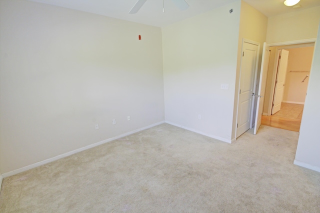 unfurnished room featuring light carpet and ceiling fan