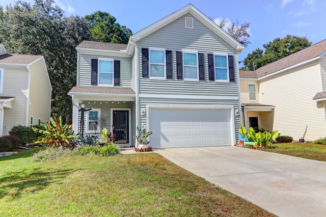 view of front of house featuring a front yard and a garage