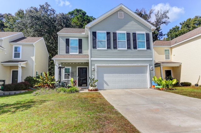 view of property featuring a front yard and a garage