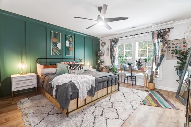 bedroom with ceiling fan and hardwood / wood-style floors