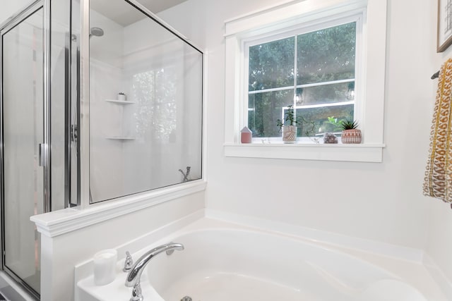 bathroom featuring independent shower and bath