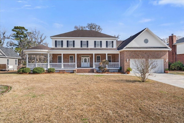 view of front facade with a garage, a front yard, and covered porch