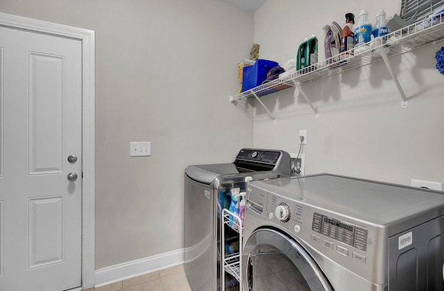 clothes washing area featuring independent washer and dryer and light tile floors