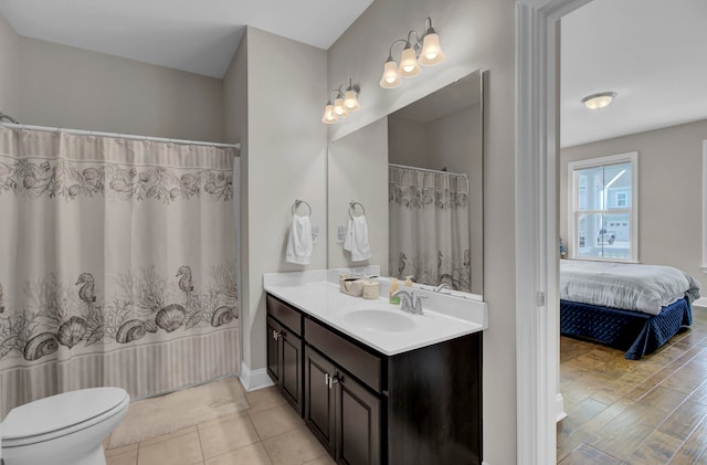 bathroom featuring tile flooring, oversized vanity, and toilet