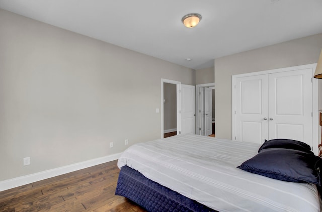 bedroom with a closet and dark wood-type flooring