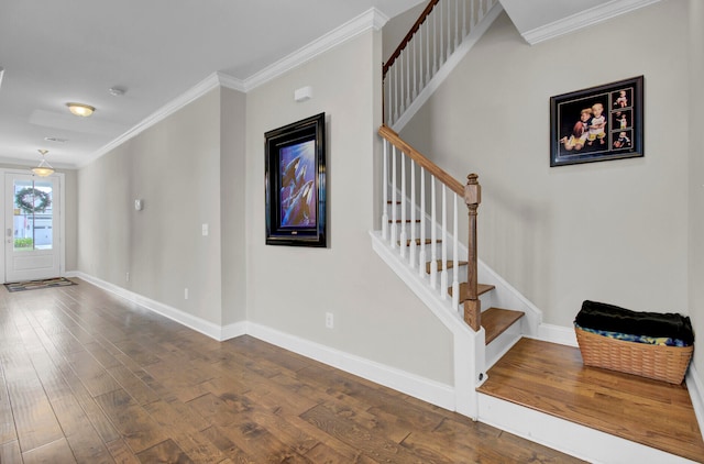 stairway featuring crown molding and dark hardwood / wood-style flooring