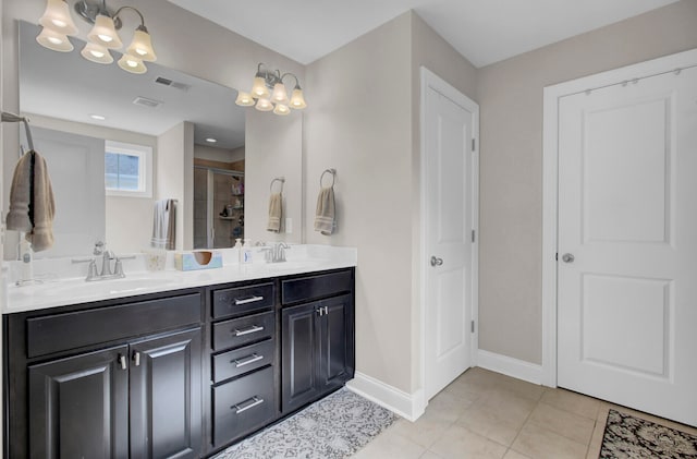 bathroom with tile floors, a chandelier, and dual vanity