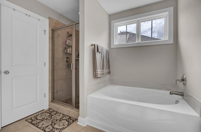 bathroom featuring independent shower and bath and tile floors