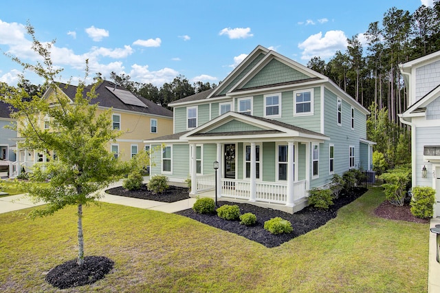 view of front of home featuring a front yard and solar panels