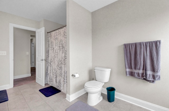 bathroom featuring tile floors and toilet