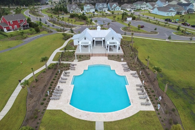 view of swimming pool featuring a patio and a lawn