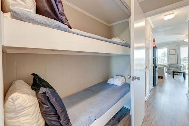 bedroom featuring crown molding and wood finished floors