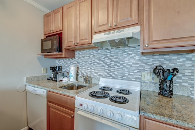 kitchen with under cabinet range hood, white appliances, tasteful backsplash, and a sink