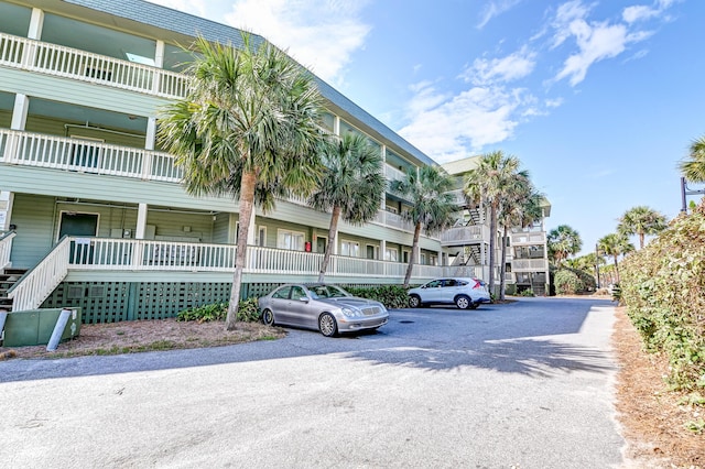 view of building exterior featuring uncovered parking