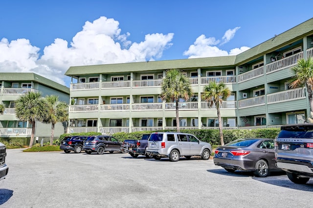 view of property featuring uncovered parking