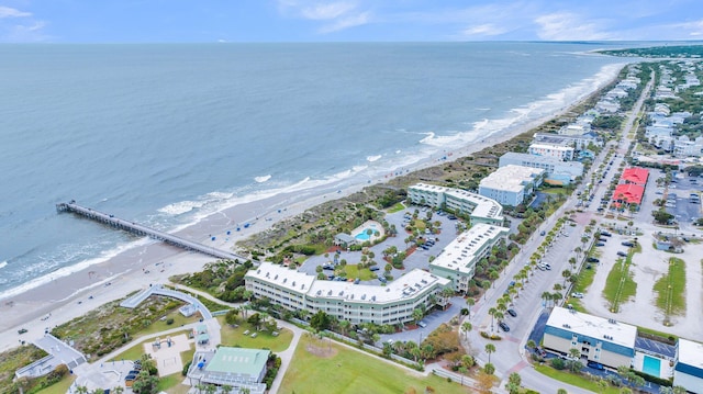 drone / aerial view featuring a water view and a view of the beach