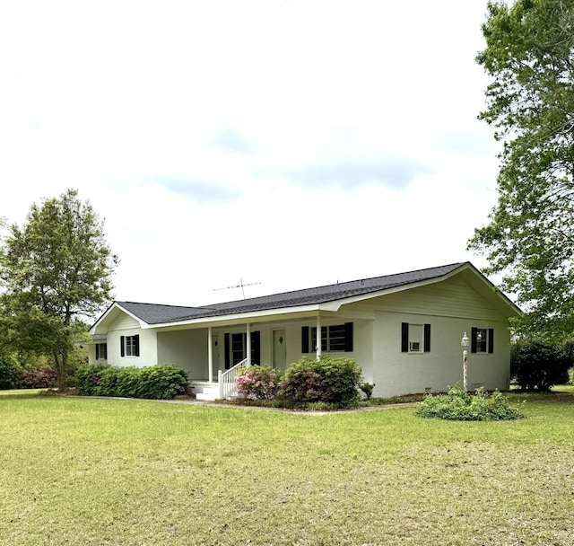rear view of property featuring stucco siding, a yard, and a porch