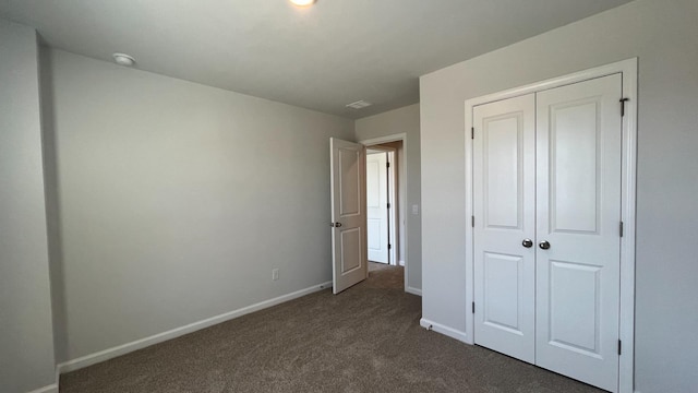 158 Yarrow Way, Moncks Corner, SC 29461 - unfurnished bedroom featuring baseboards, a closet, and dark colored carpet