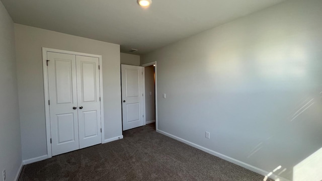 158 Yarrow Way, Moncks Corner, SC 29461 - unfurnished bedroom featuring baseboards, visible vents, a closet, and dark colored carpet