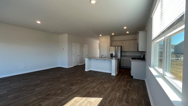 158 Yarrow Way, Moncks Corner, SC 29461 - kitchen featuring plenty of natural light, dark wood-style floors, a kitchen island with sink, and stainless steel refrigerator with ice dispenser