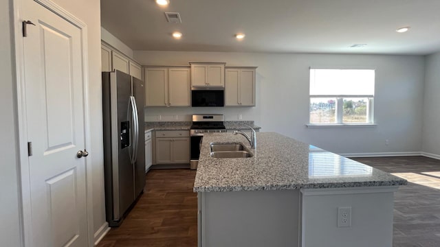 158 Yarrow Way, Moncks Corner, SC 29461 - kitchen with dark wood-style flooring, visible vents, stainless steel appliances, a sink, and an island with sink