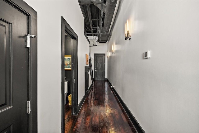 hallway with baseboards and dark wood finished floors