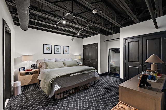 bedroom featuring dark carpet