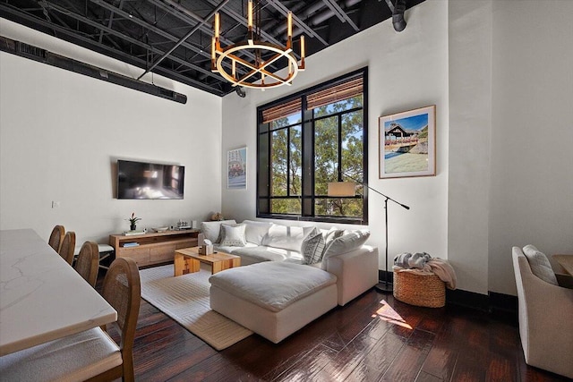 living area featuring an inviting chandelier and hardwood / wood-style flooring