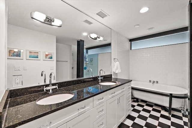 bathroom featuring a sink, tile patterned floors, and visible vents