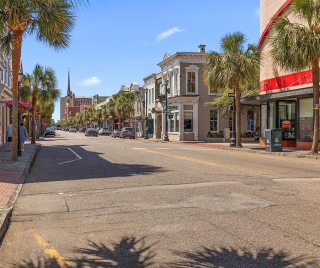 view of street featuring sidewalks, curbs, and street lights