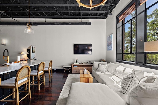 living room with wood finished floors and a healthy amount of sunlight